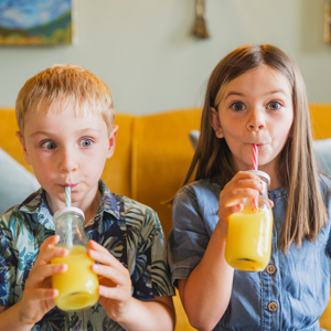 Kids drinking orange juice