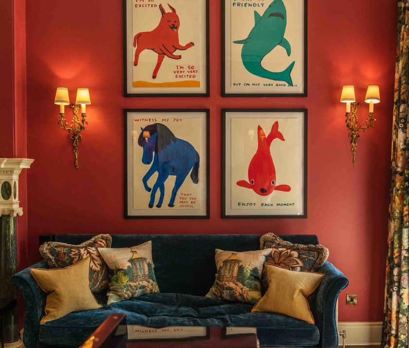 Stylish sitting area at the Cromlix Hotel with bold animal art and plush velvet sofa.